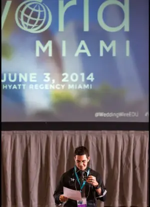 David speaking at a podium at an event in Miami