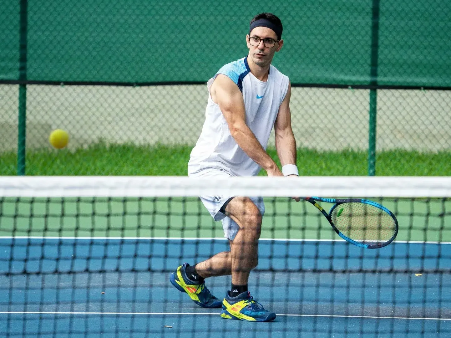 David about to hit a tennis ball at the net
