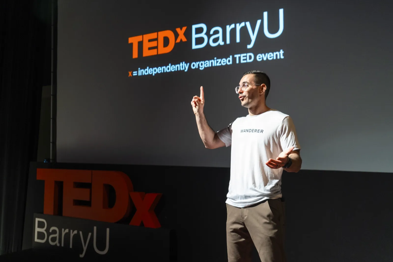 David Bitton speaking on the TEDx Barry University stage
