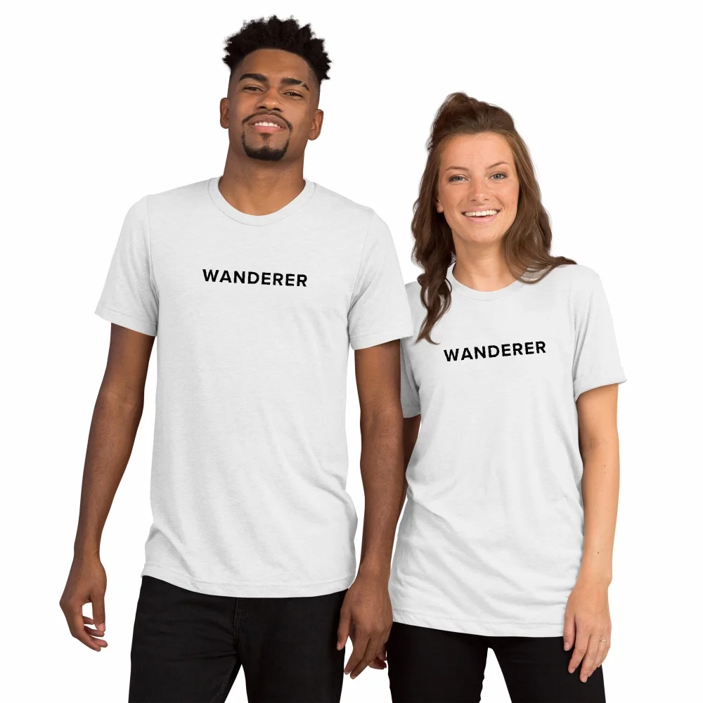 Two people wearing white Wanderer t-shirts with black text